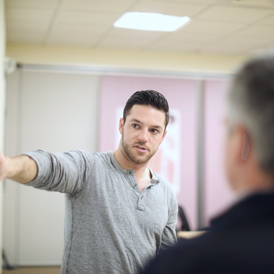Engineer explaining a design to a colleague during a quality review