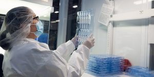 Cleanroom operator inspecting a clear molded tray Cleanroom operator inspecting a clear molded tray