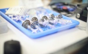 Tray of single-use luer connector components prepared for kitting
